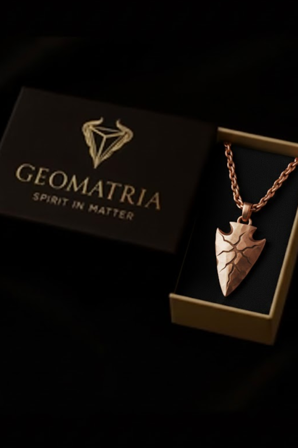 A necklace with a pendant is displayed in a box with the text "Geomatria Spirit in Matter" printed on it.