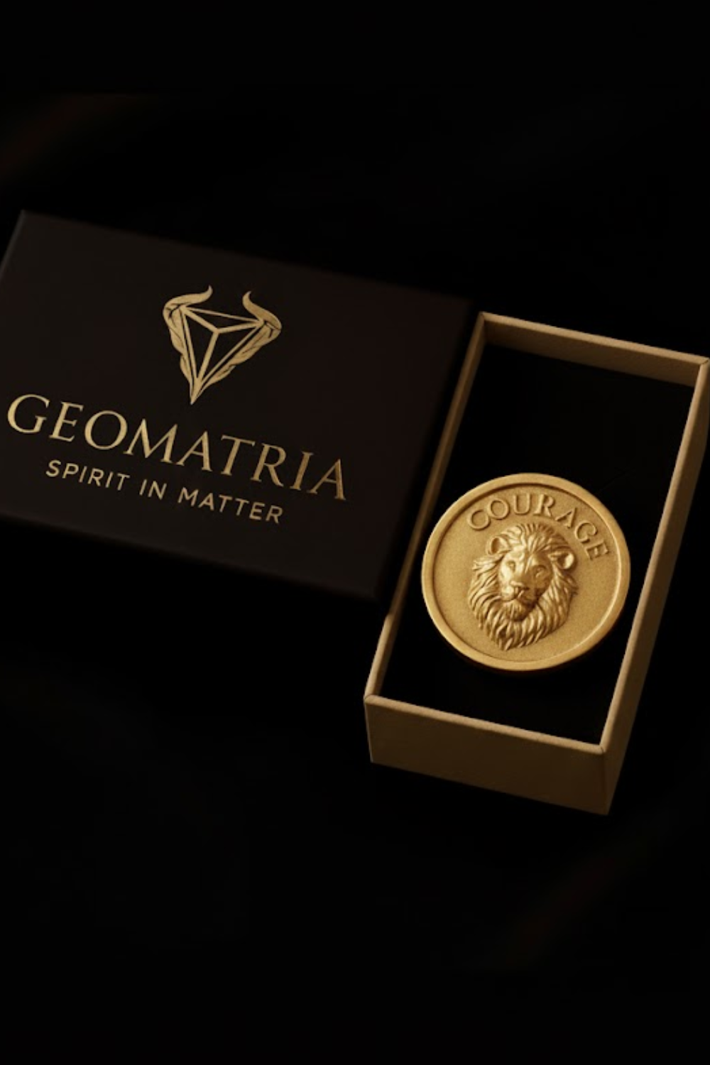 a gold lion head medallion placed inside a black box with the word "Geomatria" printed on it.