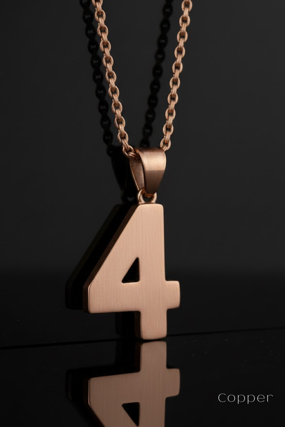 A copper-colored pendant necklace with the number 4 prominently displayed.