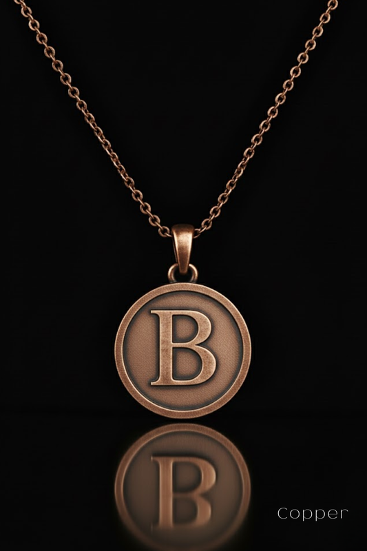 A copper-colored pendant necklace with a large circular pendant featuring the letter "B" in the center.