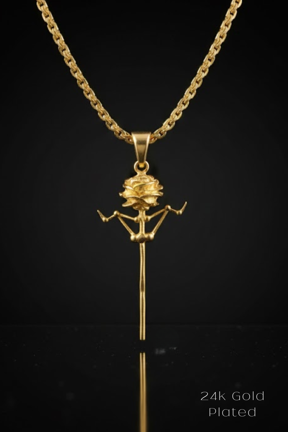 A 24k gold plated pendant featuring a gold rose design on a chain.