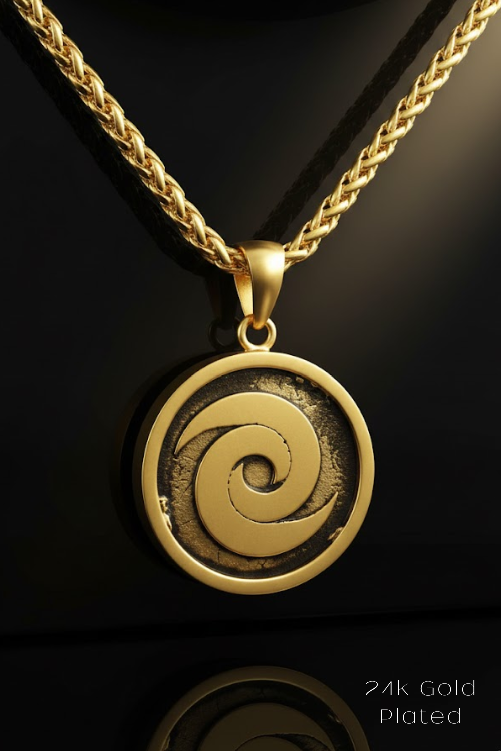 A gold-plated pendant with a circular design featuring a spiral motif, suspended from a chain.