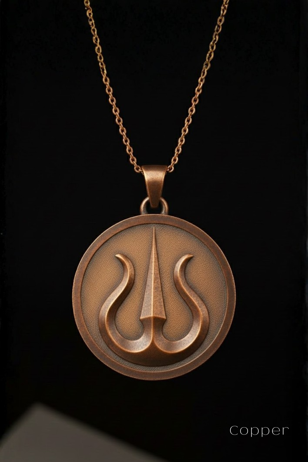 A copper-colored pendant necklace with a circular medallion featuring a stylized symbol.