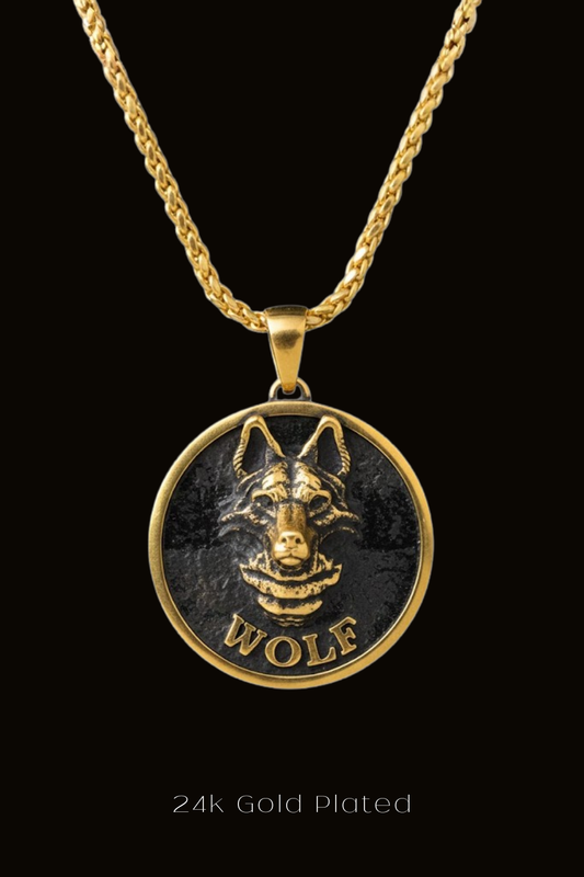 A gold-plated pendant featuring a detailed engraved image of a wolf's head.
