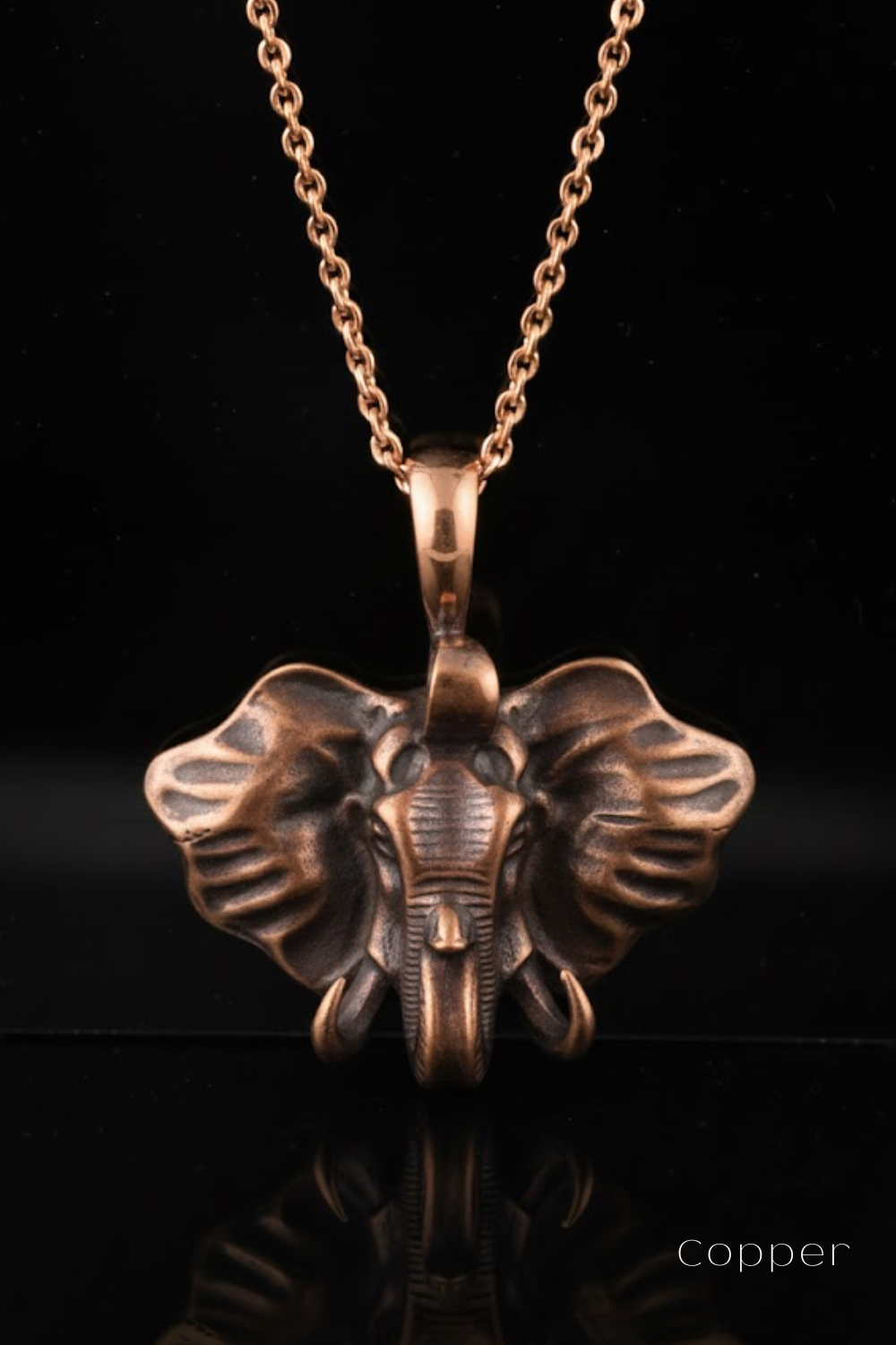 A copper-colored pendant necklace with a detailed elephant head design.