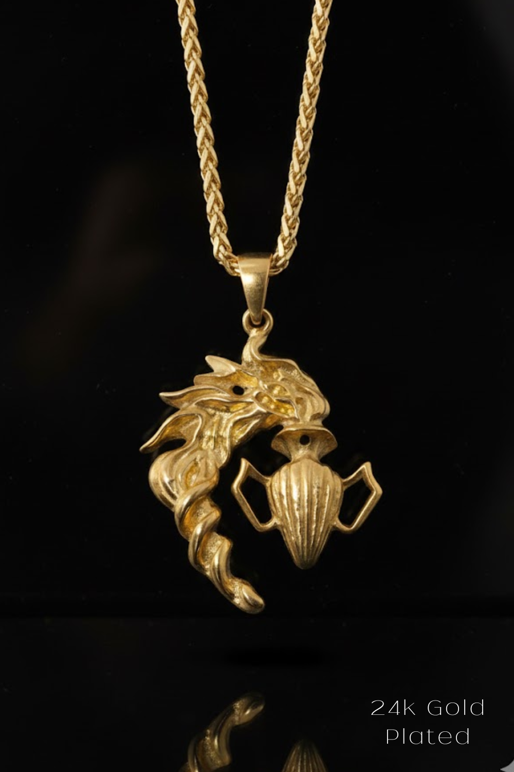 A 24k gold plated pendant featuring a dragon design on a chain necklace.