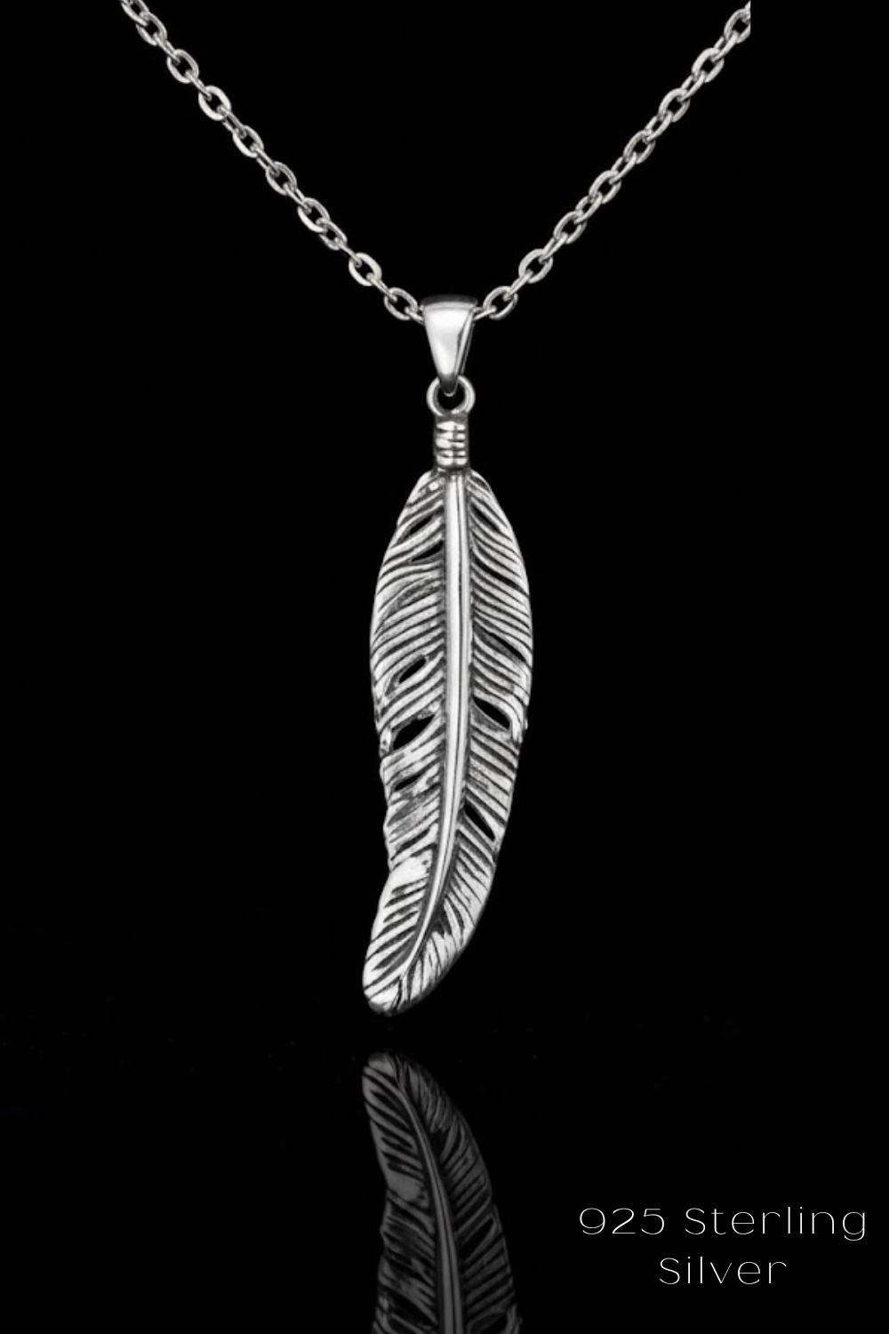 A silver-toned pendant necklace with a single feather pendant against a black background.