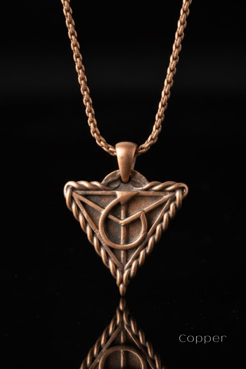 A copper-colored pendant necklace with a triangular pendant featuring a symbol or design.