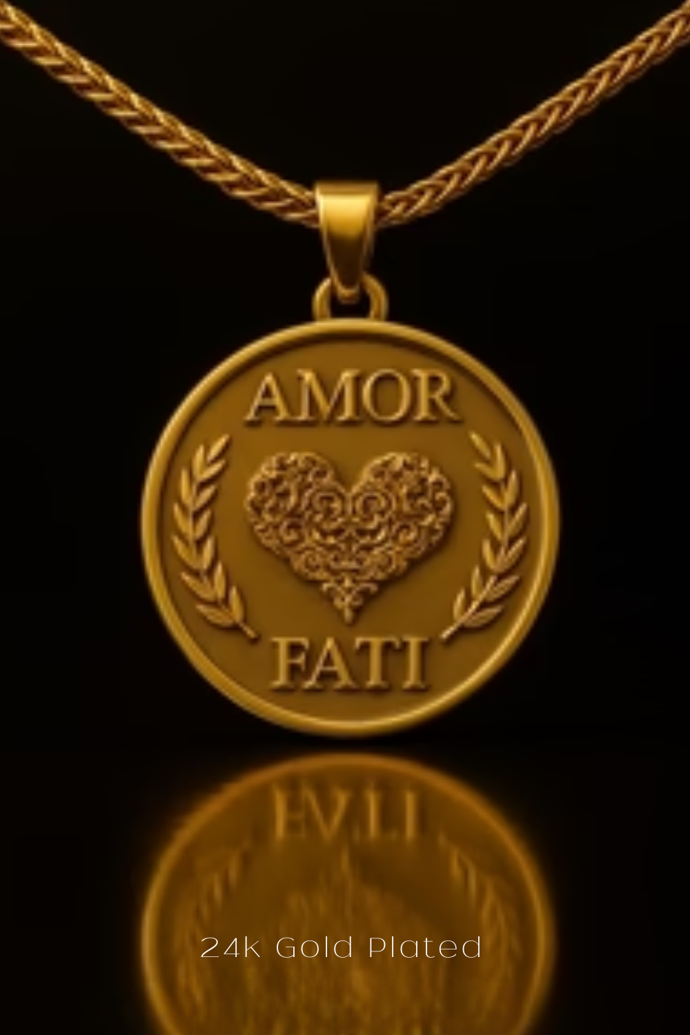 a gold-plated pendant with the words "Amor Fati" engraved on it, which means "love and wealth" in Italian. The pendant is displayed against a black background, and its reflection can be seen in the foreground.