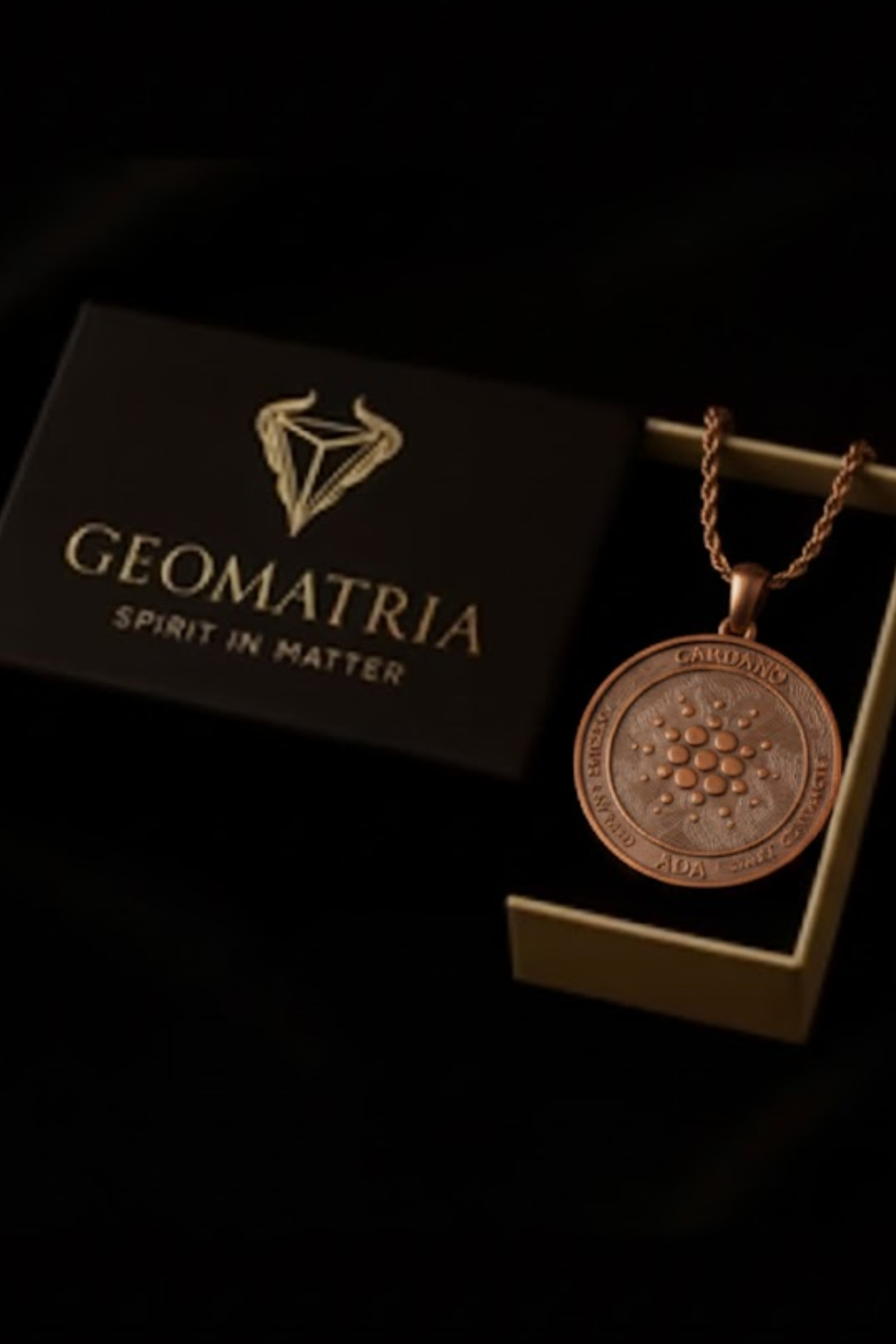 a pendant necklace with a circular pendant, placed inside a black box with the word "Geomatria" written on it.