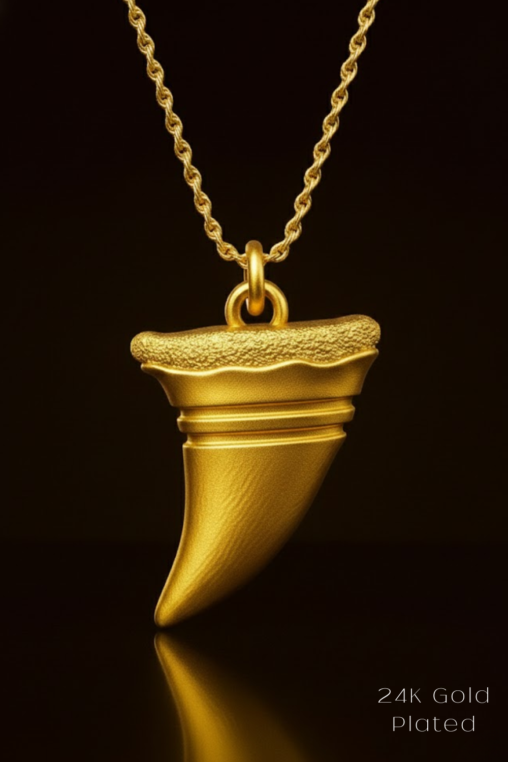 A gold-colored pendant with a textured surface hangs against a black background.