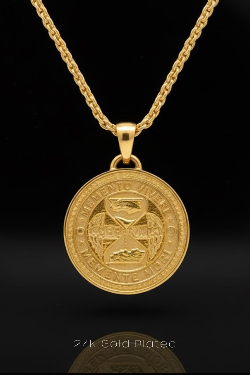 A 24k gold-plated pendant necklace with a circular medallion featuring an engraved design.
