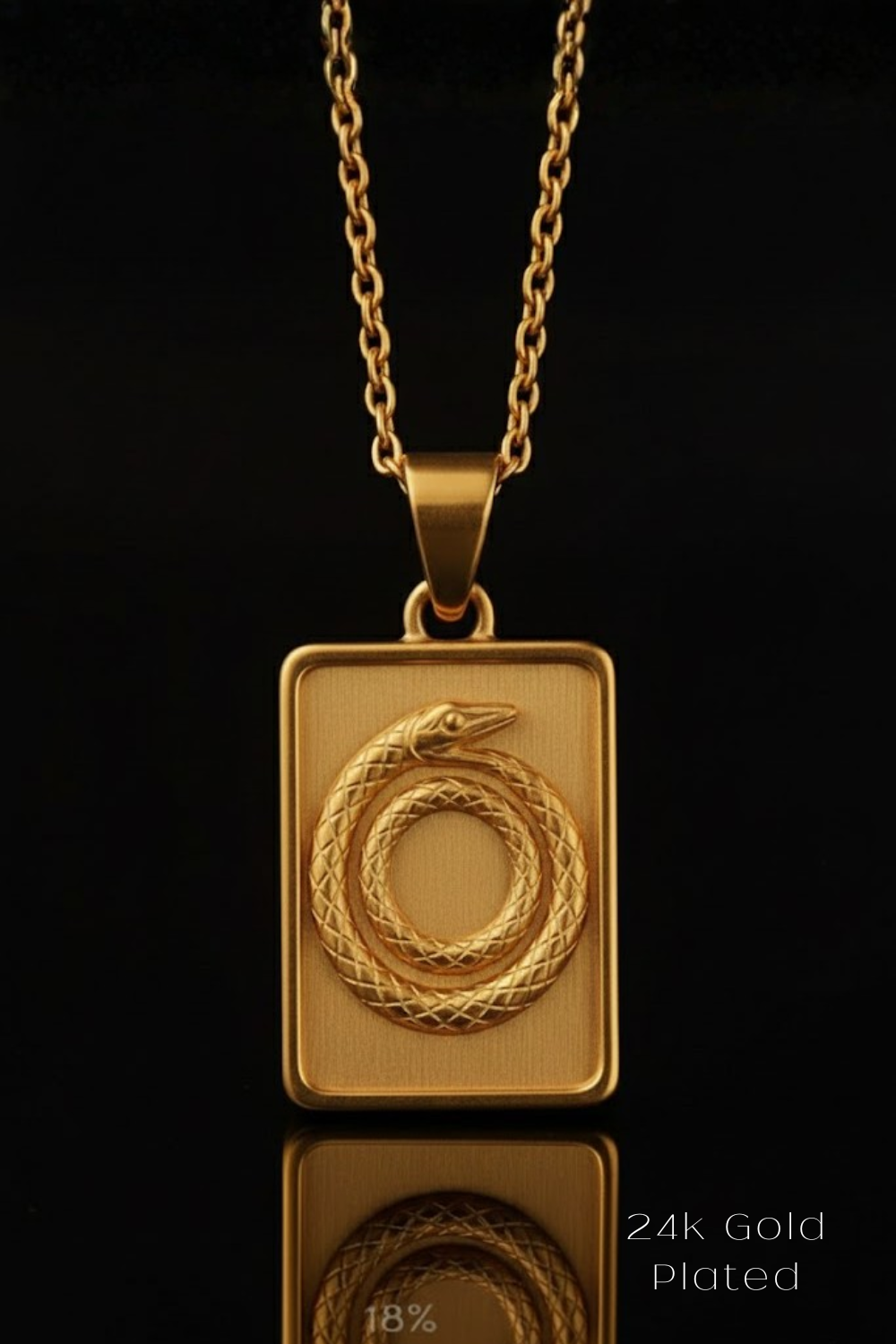 A gold-colored pendant necklace with a rectangular pendant featuring a snake design.