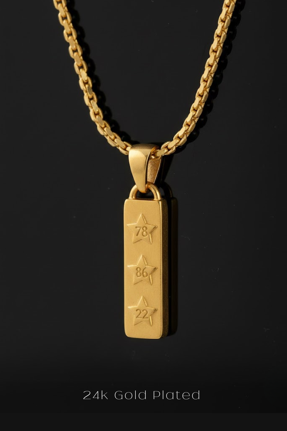 A 24k gold-plated necklace with a rectangular pendant featuring three stars and the numbers '78', '86', and '22' engraved on it.