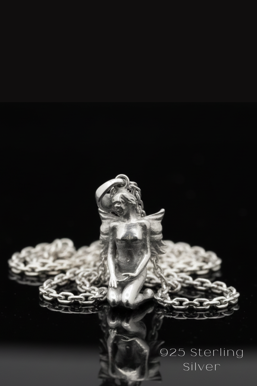 A silver-colored pendant in the shape of a fairy or winged figure, with a chain around it, is displayed against a black background.