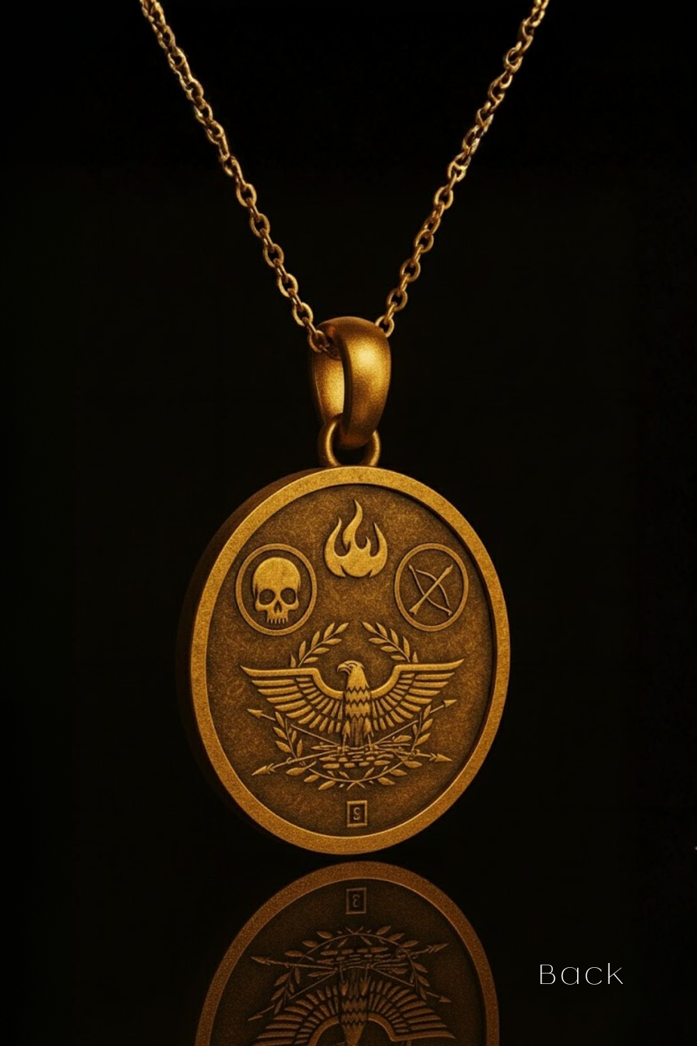 A gold-colored pendant necklace with a circular medallion featuring an eagle, skull, and flame design.
