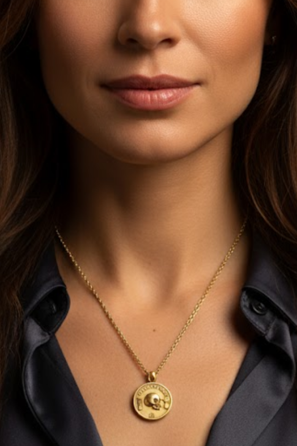 A close-up of a woman's neck and chest area, with a gold necklace featuring a pendant.