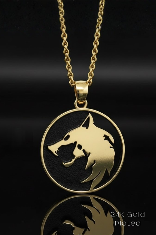 A gold-colored pendant necklace with a circular pendant featuring a stylized wolf or wolf-like creature design.