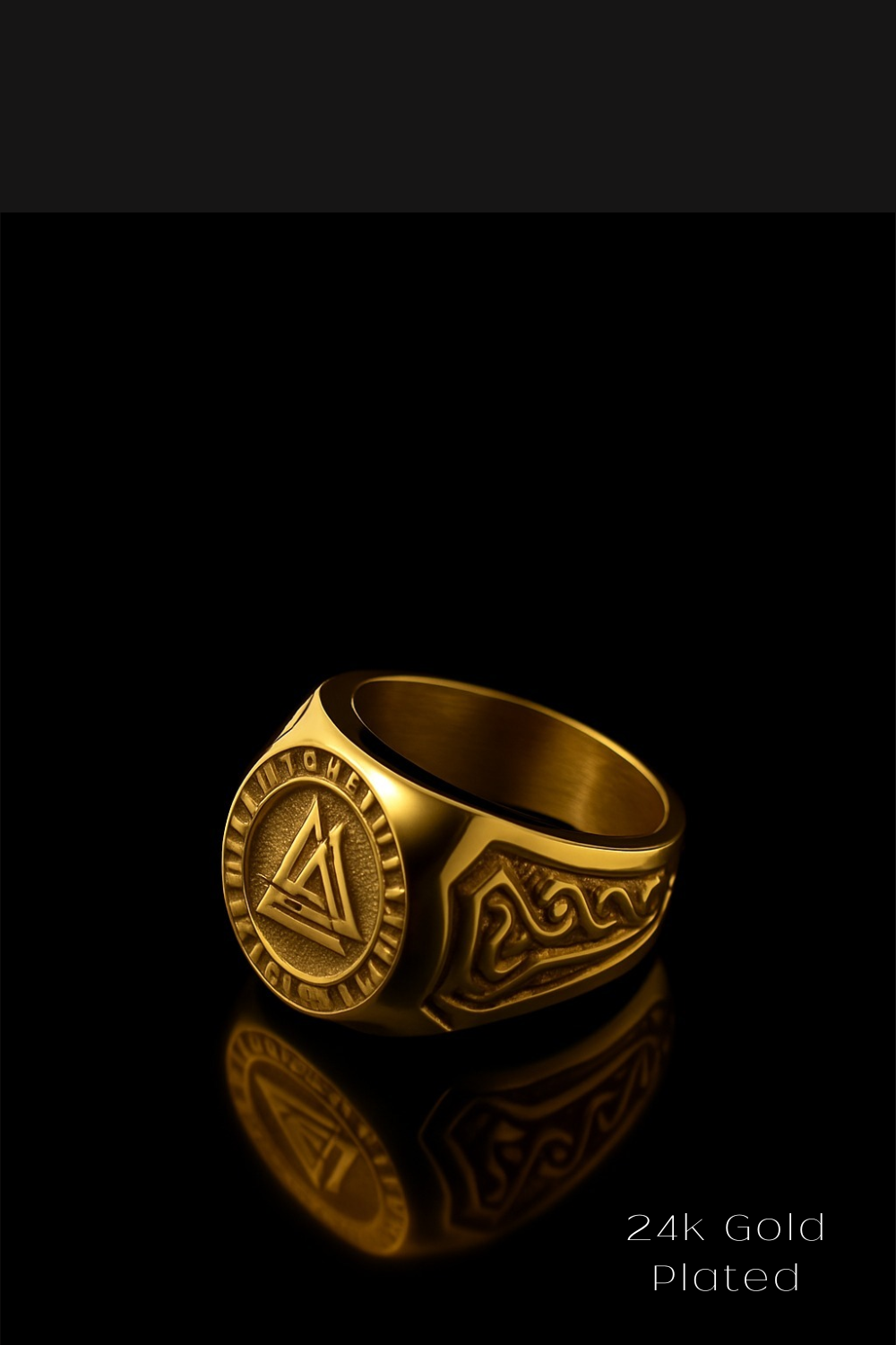 A gold ring with a circular emblem and intricate designs, set against a black background.