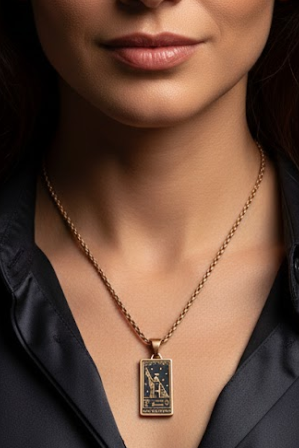 A close-up of a woman's neck and chest area, with a gold-colored necklace featuring a pendant.