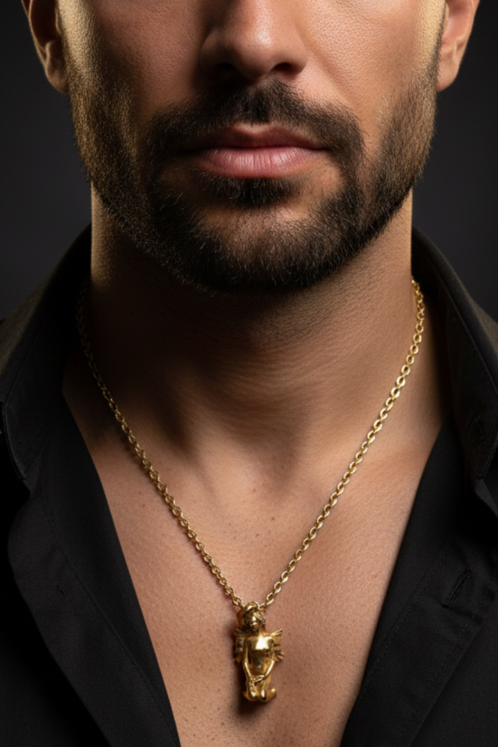 A close-up of a man's neck and chest area, with a gold necklace and a pendant visible.