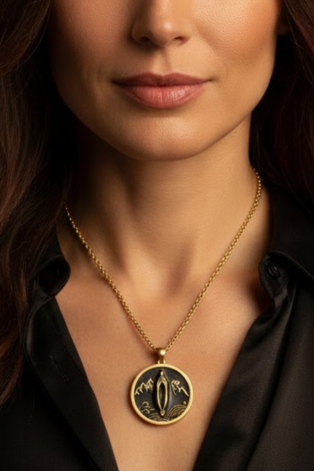 A close-up of a woman's neck and chest area, with a gold necklace featuring a pendant.
