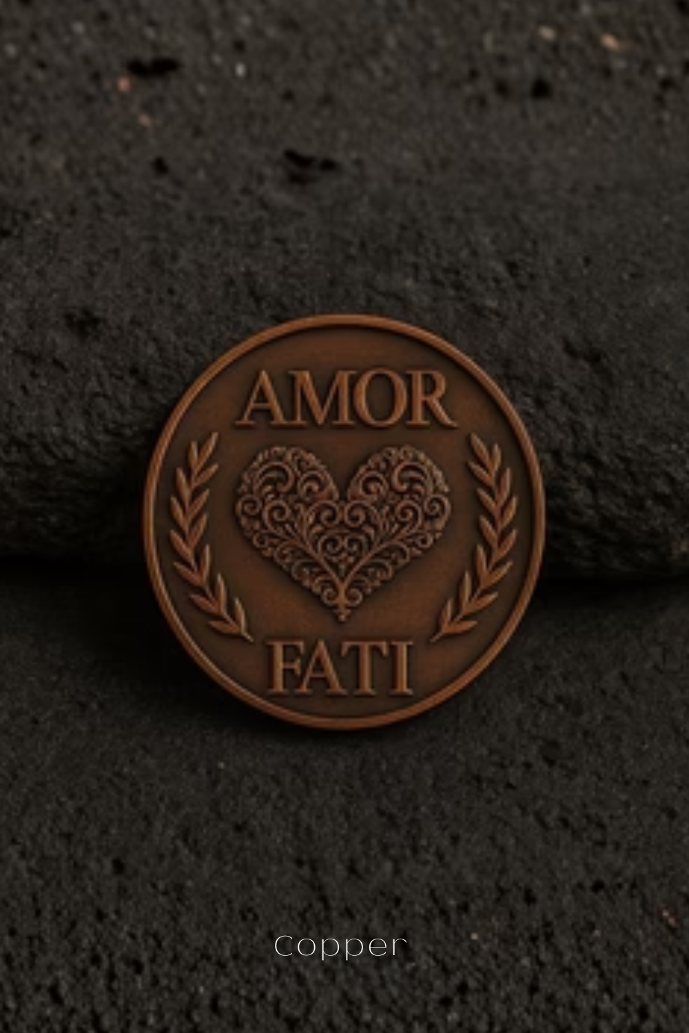 a close-up of a copper-colored coin with the words "AMOR FAMI" and a heart design, resting on a dark surface.