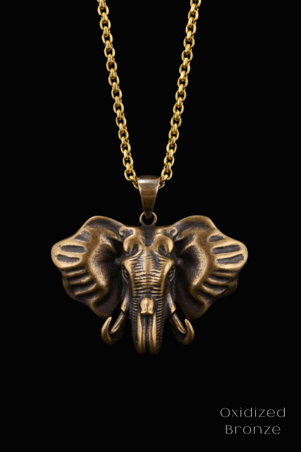 A gold-colored pendant featuring a detailed bronze elephant head design.