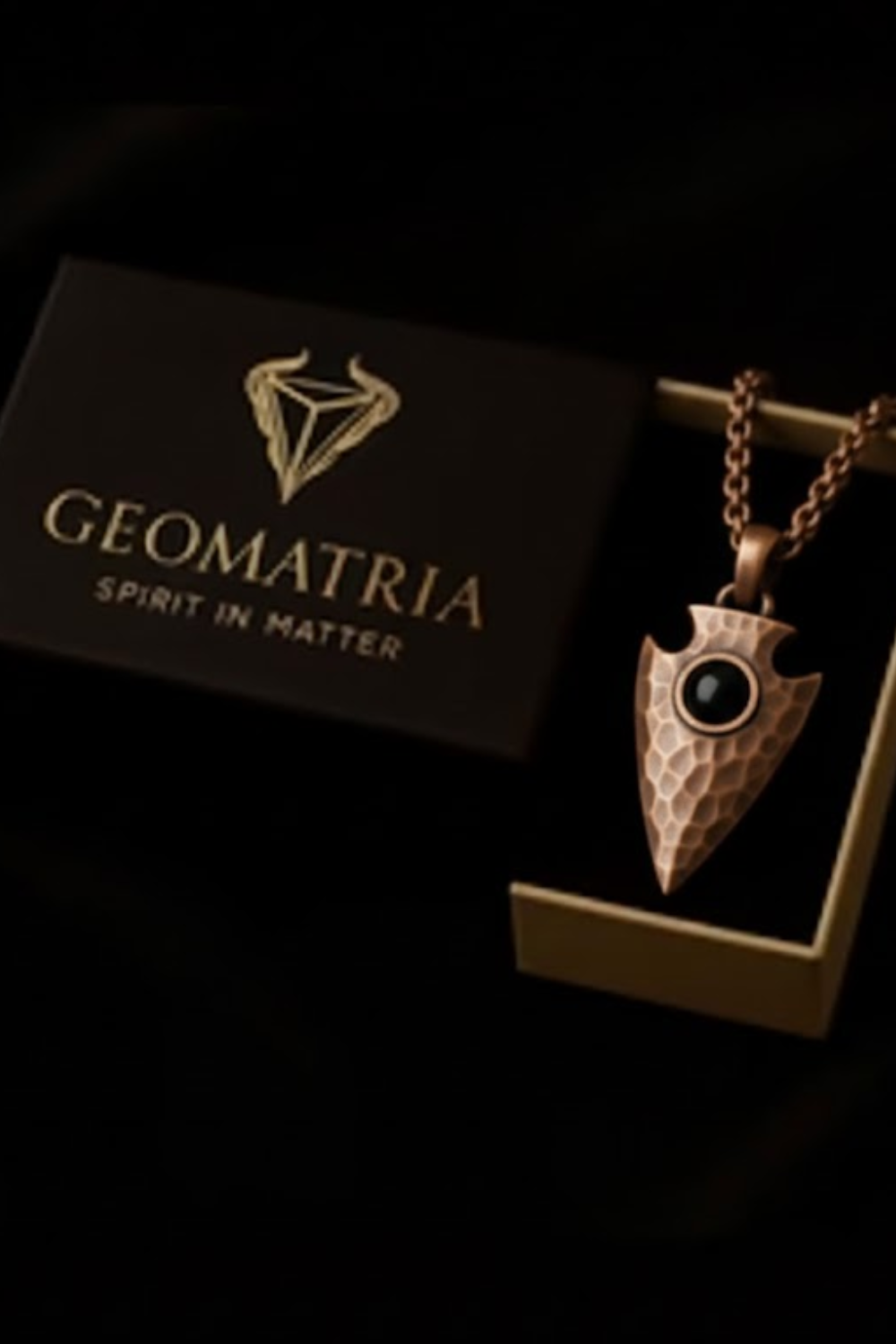 a necklace with a pendant, displayed in a box with the brand name "Geomatria" written on it.