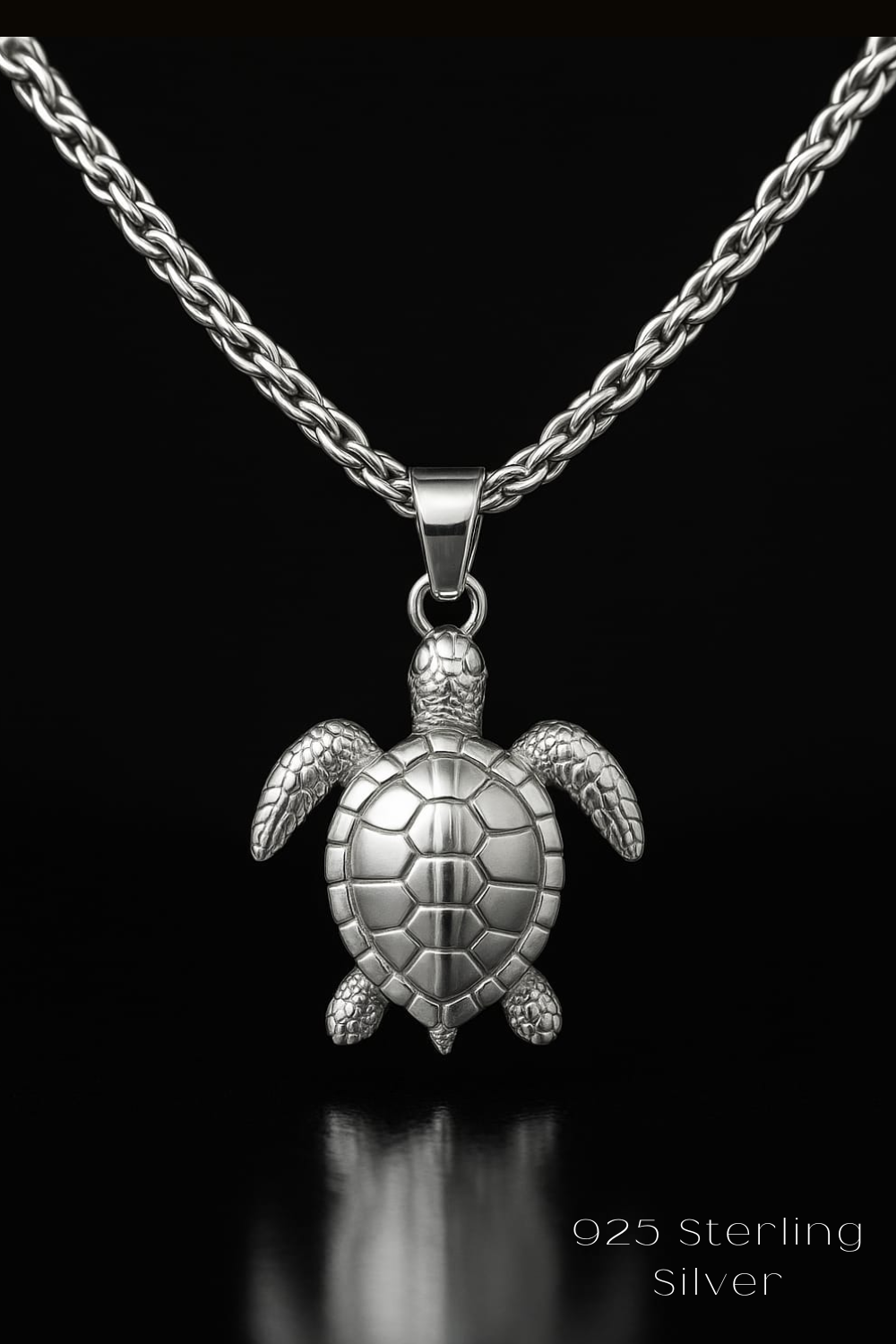 A silver necklace with a pendant in the shape of a turtle.