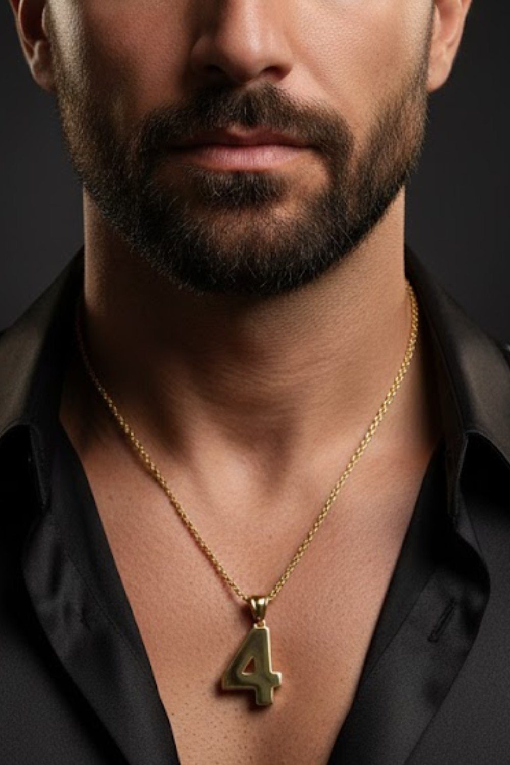 A close-up of a man's neck and chest area, with a gold-colored pendant necklace featuring the number 4 prominently displayed.