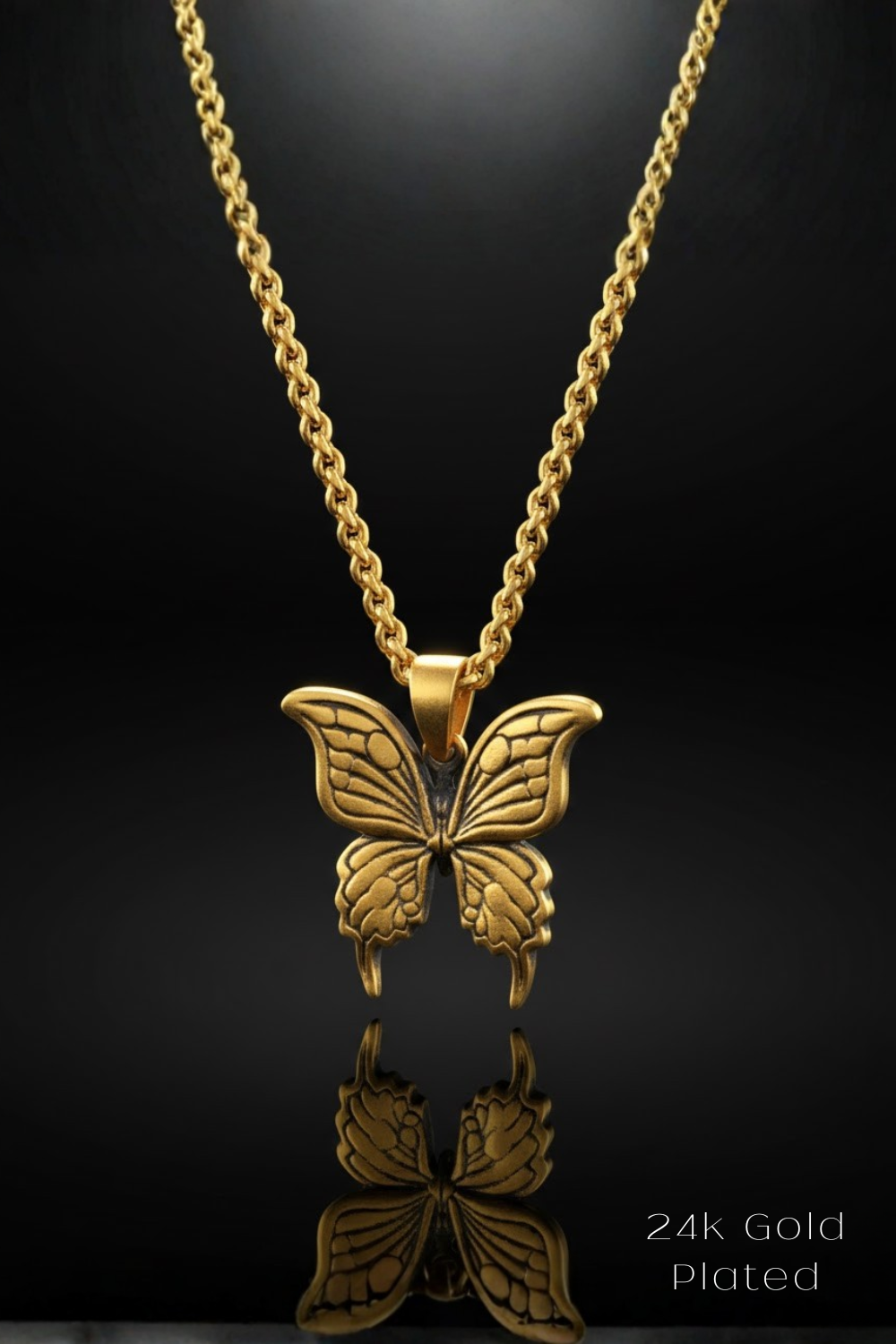 A 24k gold plated necklace with a butterfly pendant is displayed against a black background.