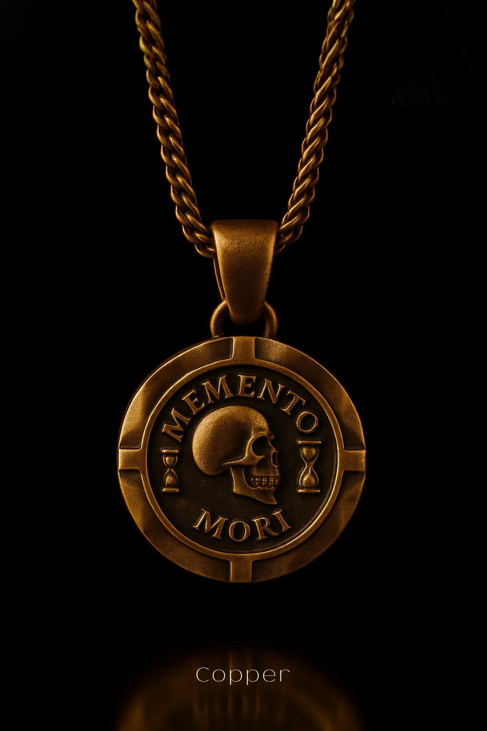 a gold-colored pendant necklace with a circular medallion featuring a skull and the Latin phrase "Memento mori" (The Memory of Death).