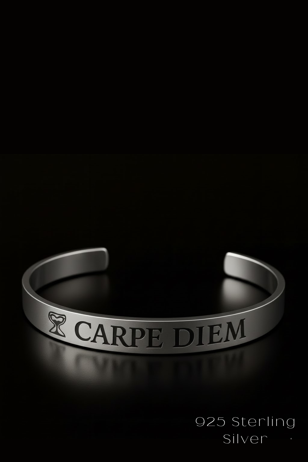 A silver bracelet with the engraved text "CARPE DIEM" on it, which means "Carpe Diem" in Latin, is shown against a black background.