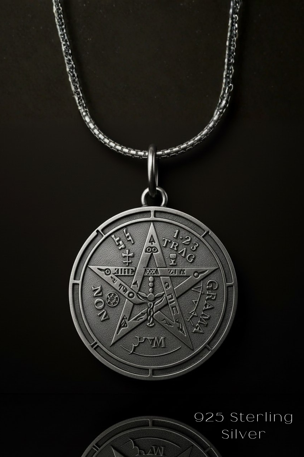 A silver-colored pendant necklace with a circular medallion featuring a pentagram design and various symbols.