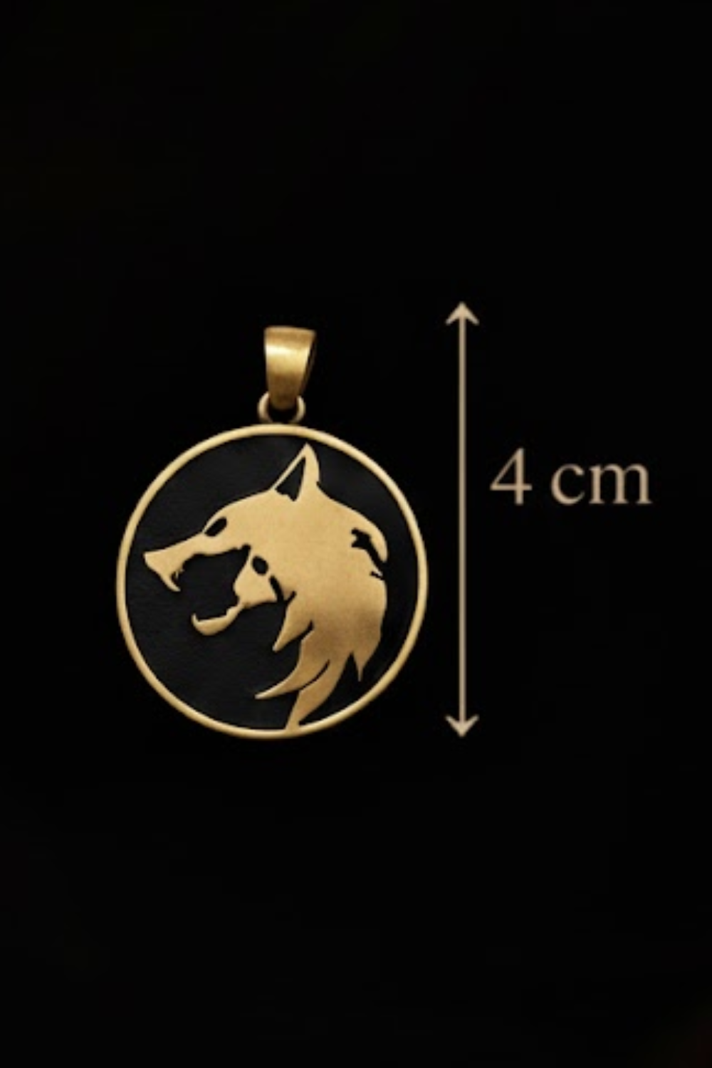 A gold-colored pendant in the shape of a wolf's head, with a black background.