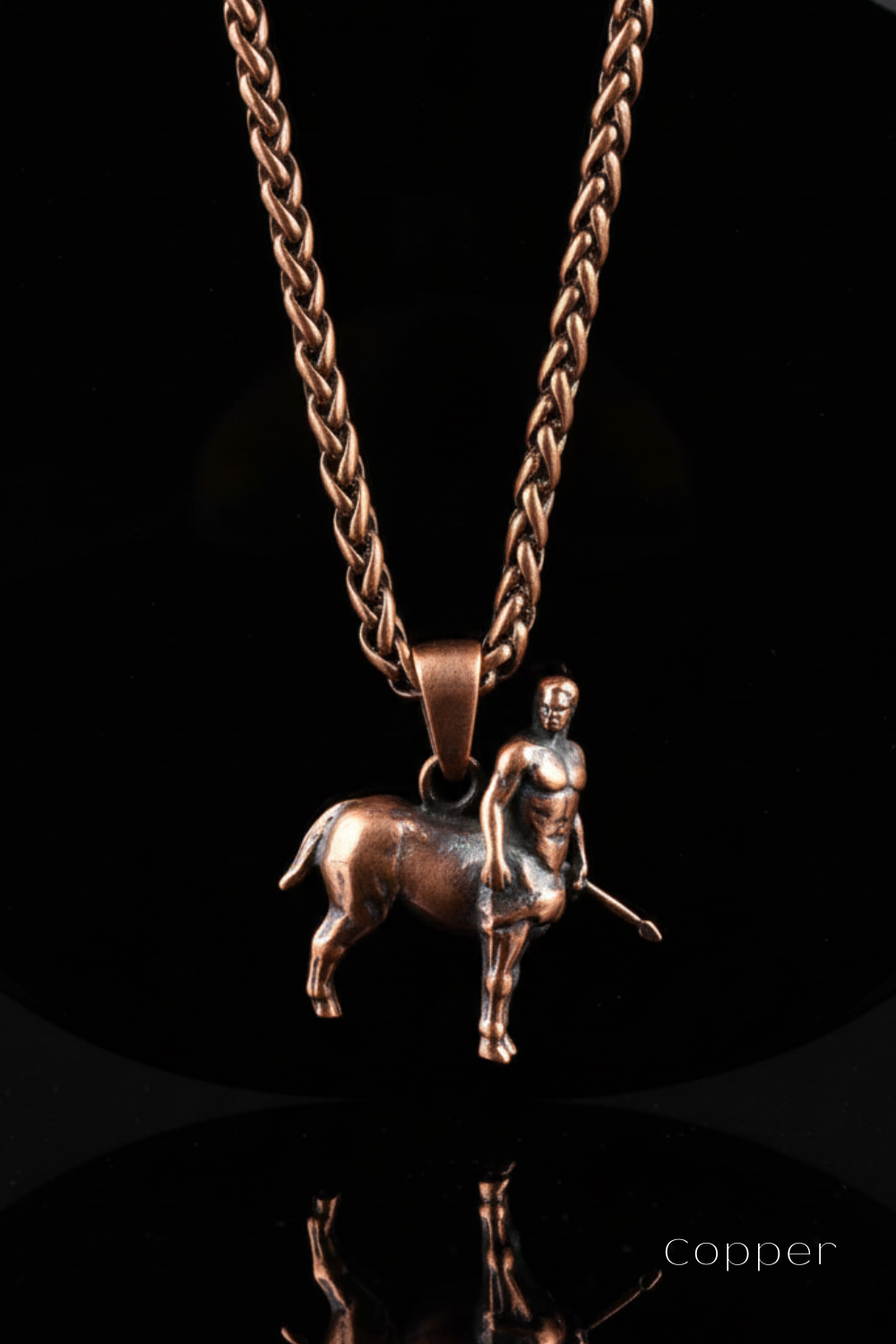 A copper-colored metal pendant necklace with a small statue of a man on a rearing horse, suspended from a chain.