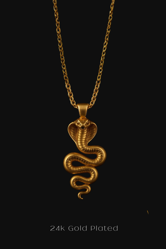 A 24k gold plated pendant featuring a snake design is shown against a black background.