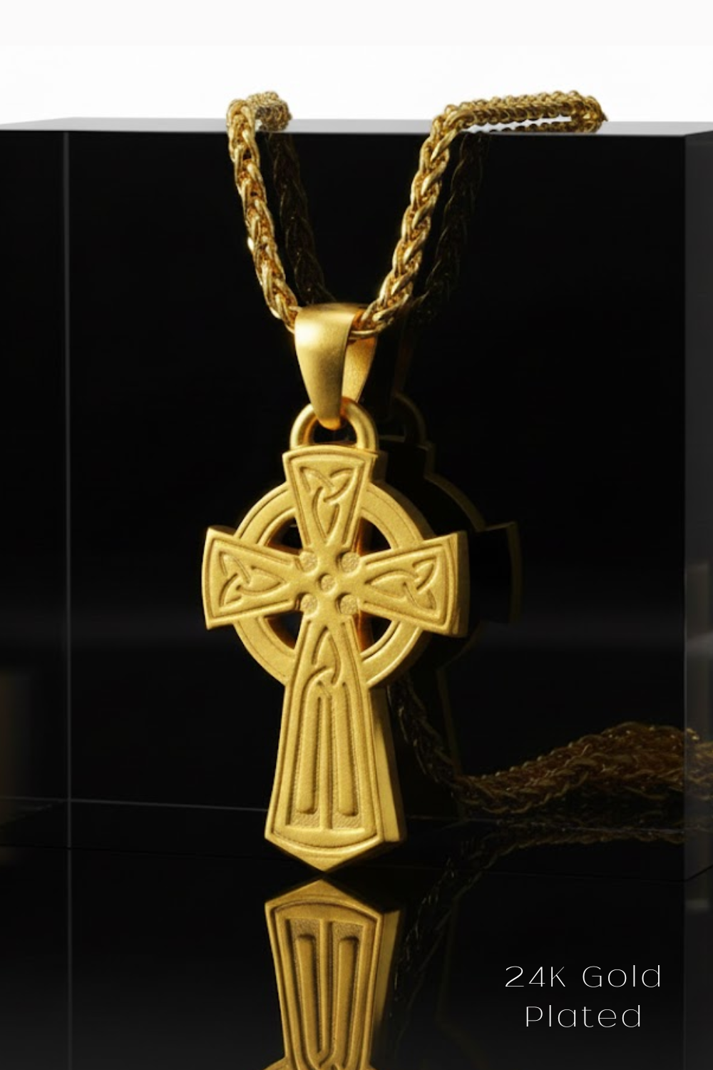 A 24K gold plated cross pendant necklace is displayed against a black background.