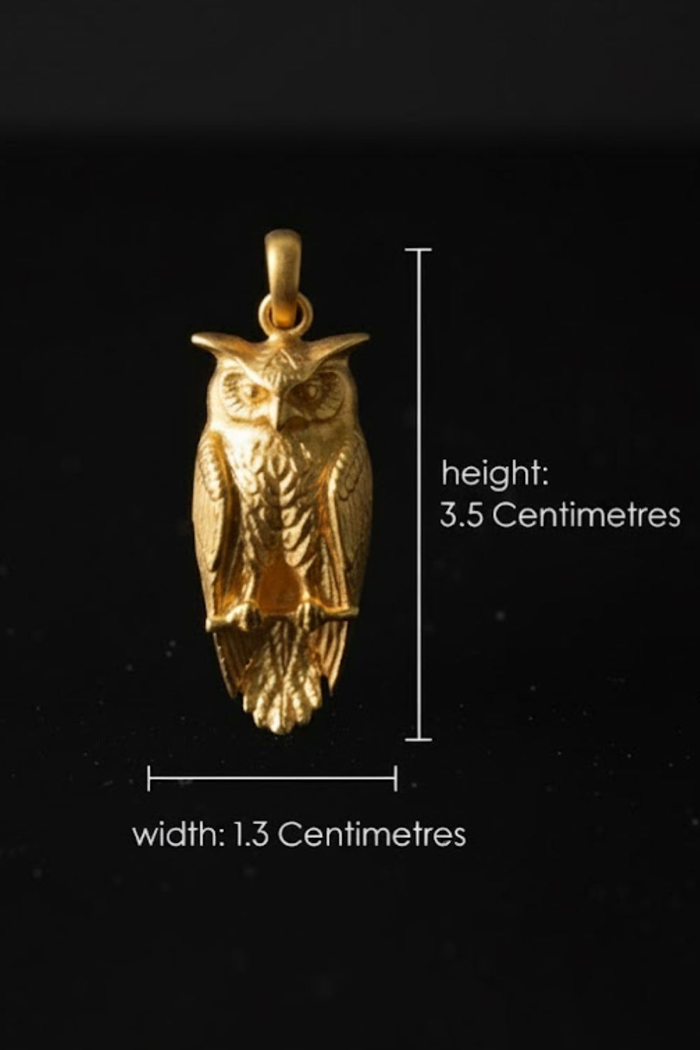 A gold-colored owl pendant is shown against a black background, with measurements and text indicating its size.