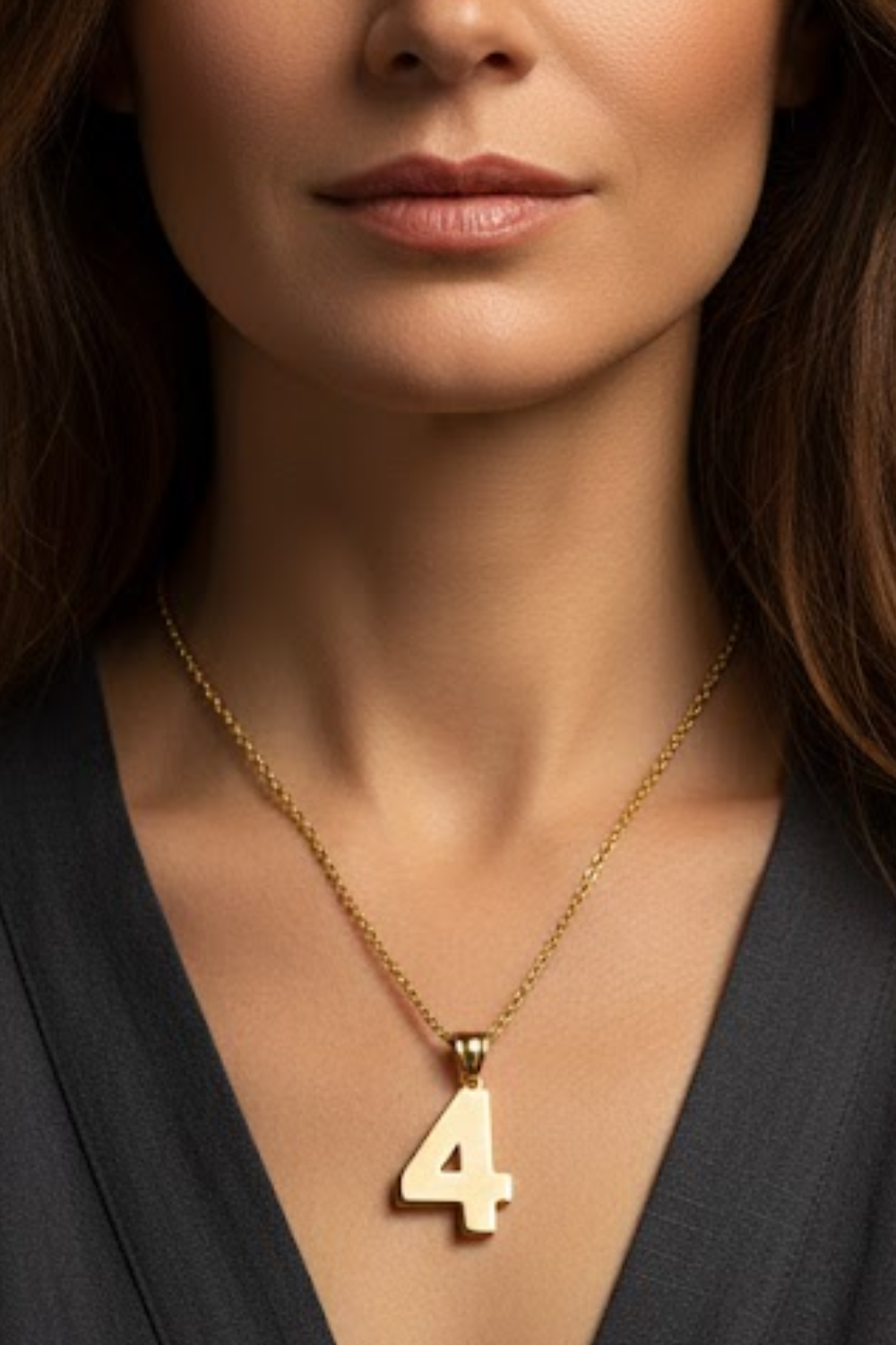 A close-up of a woman's neck and chest area, with a gold-colored pendant necklace featuring the number 4.