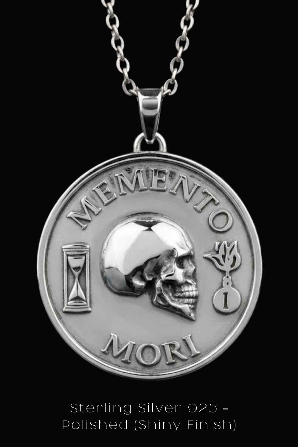 A silver medallion pendant with the text "MEMENTO MORI" and a skull design, suspended from a chain.