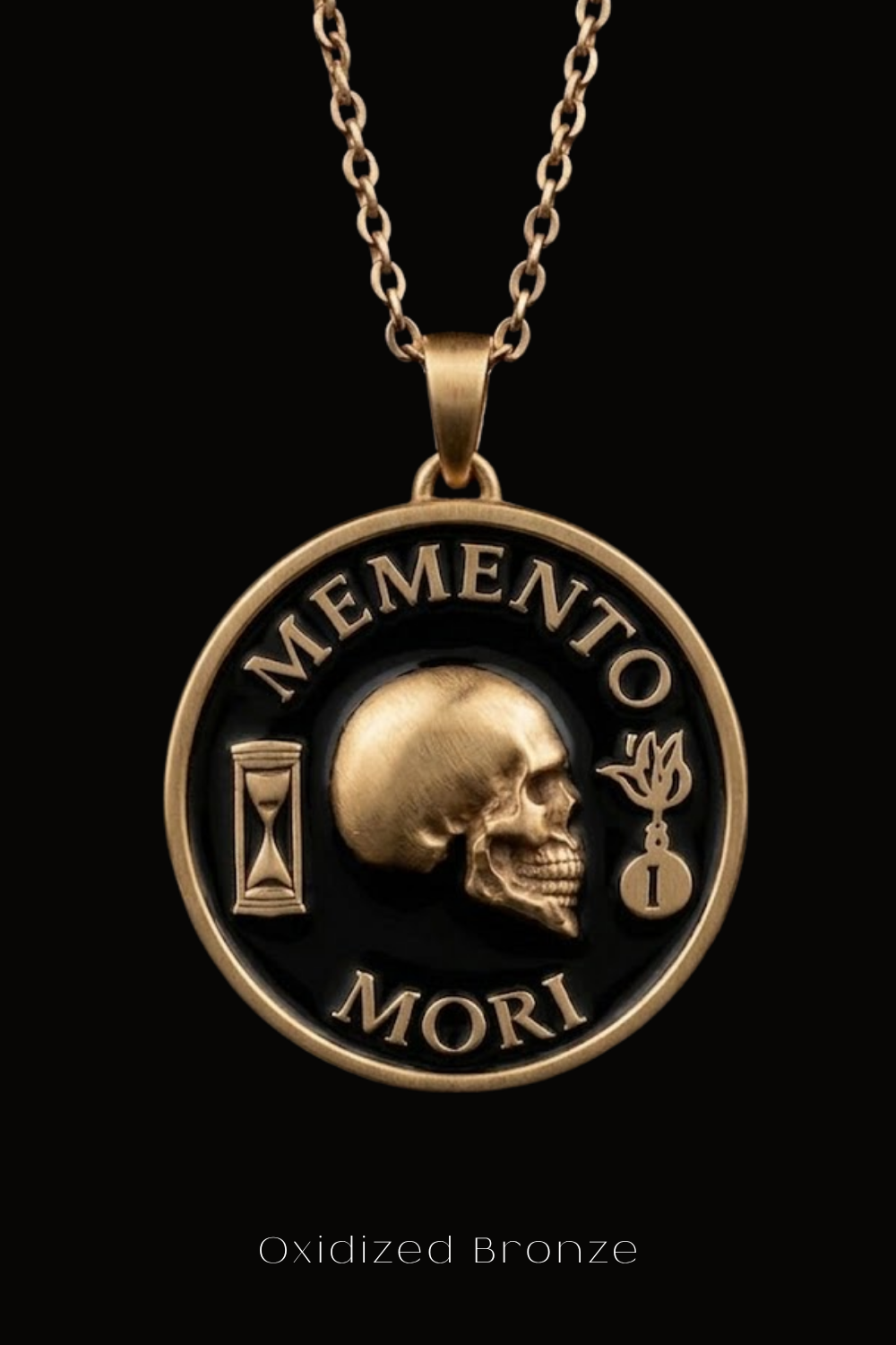 a gold-colored pendant with a black background, containing a skull and the Latin phrase "Memento mori" (which means "Remembering the dead" in English).