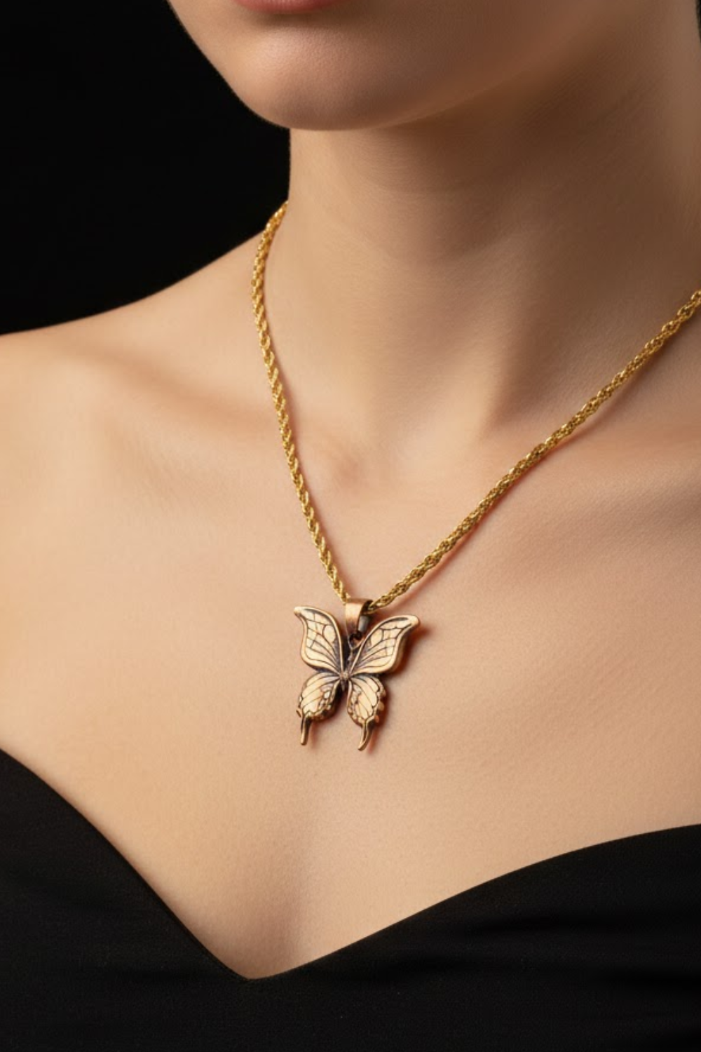 A close-up of a woman wearing a gold-colored necklace with a butterfly pendant.