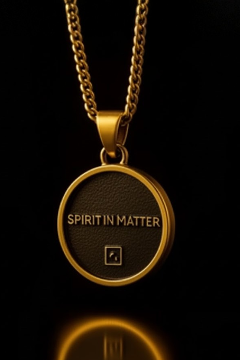 A gold-colored pendant necklace with the text "SPIRIT IN MATER" displayed on it.