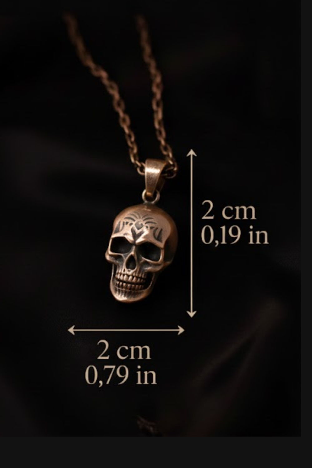 A close-up image of a pendant necklace with a skull pendant, accompanied by measurements indicating the necklace is 2 cm in length and 0.79 in width.