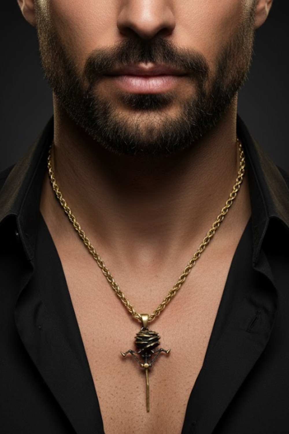 A close-up of a man's neck and chest area, with a gold chain necklace and a pendant featuring a sword-like design.