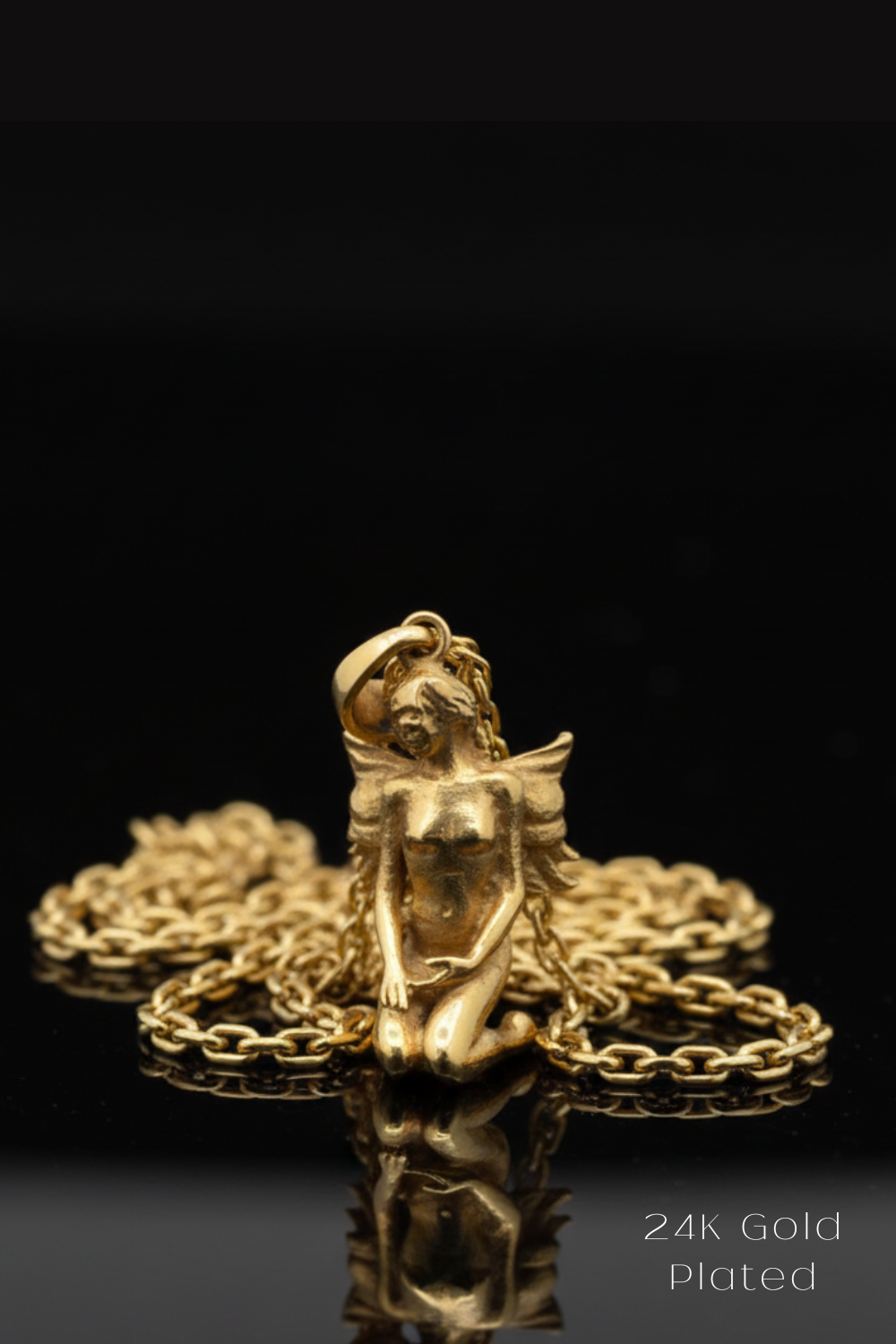 A gold-plated pendant in the shape of a female fairy or mermaid, sitting on a chain against a black background.
