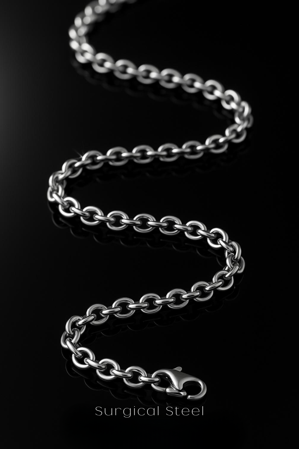 A close-up view of a surgical steel chain necklace against a black background.