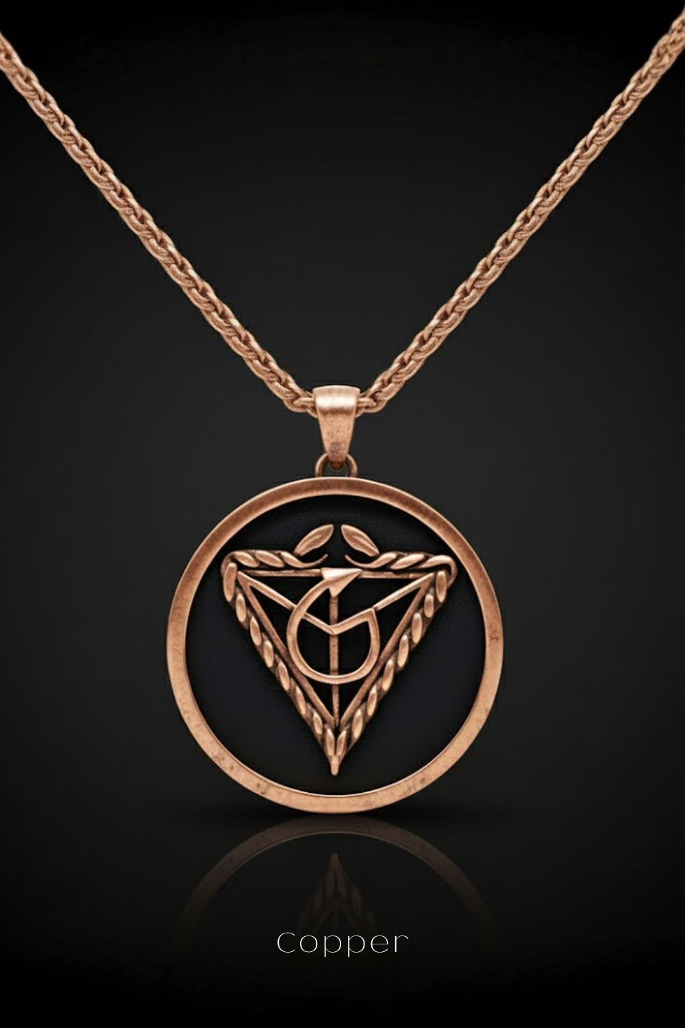 A copper-colored pendant necklace with a circular design featuring a symbol or emblem.